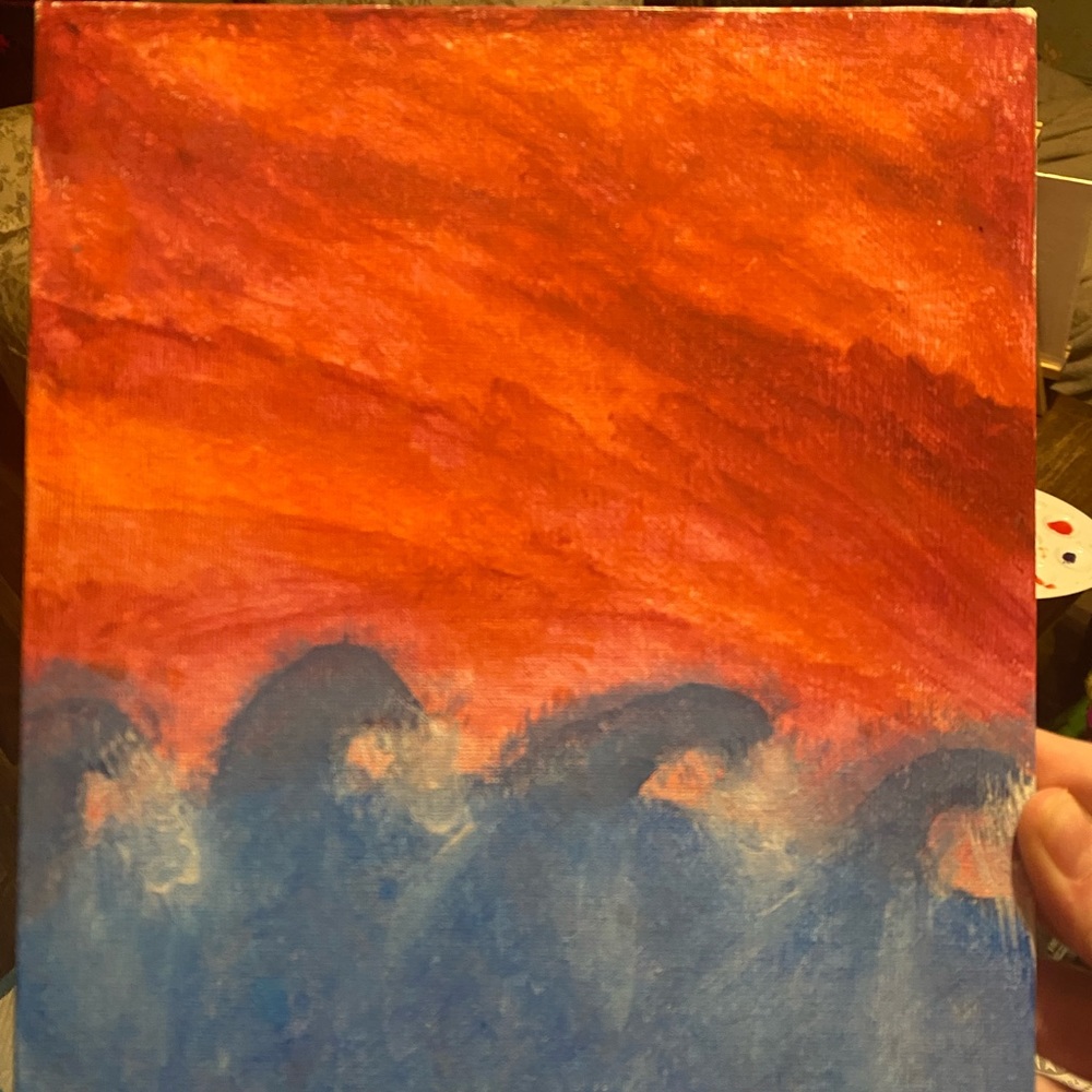 Painting of the sunset over a stormy sea